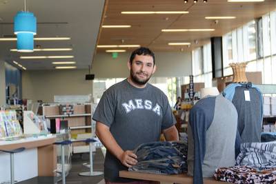 student setting up student run retail space with product